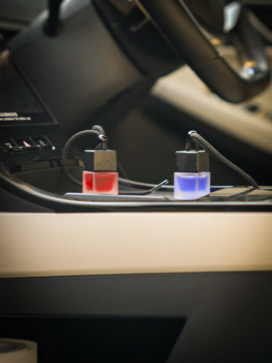 SCNTD Customise blue purple car diffuser resting against Porsche steering wheel